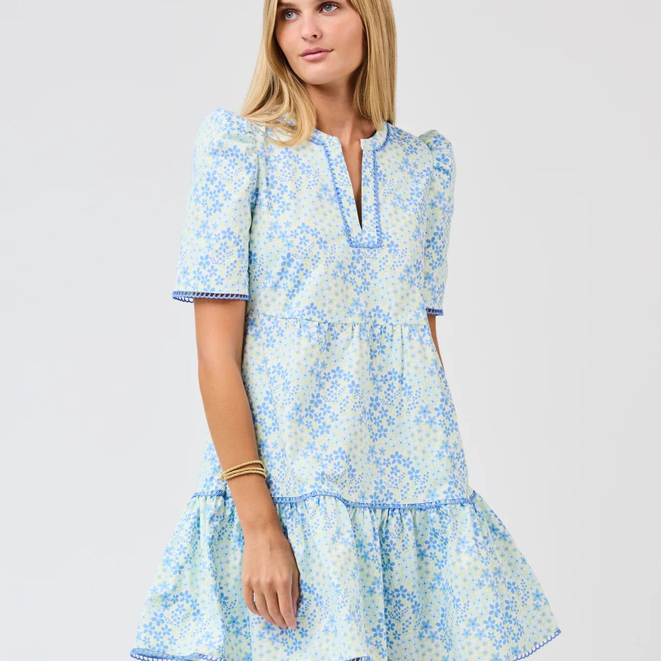 Woman wearing a blue floral dress on a white background