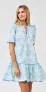 Woman wearing a blue floral dress on a white background