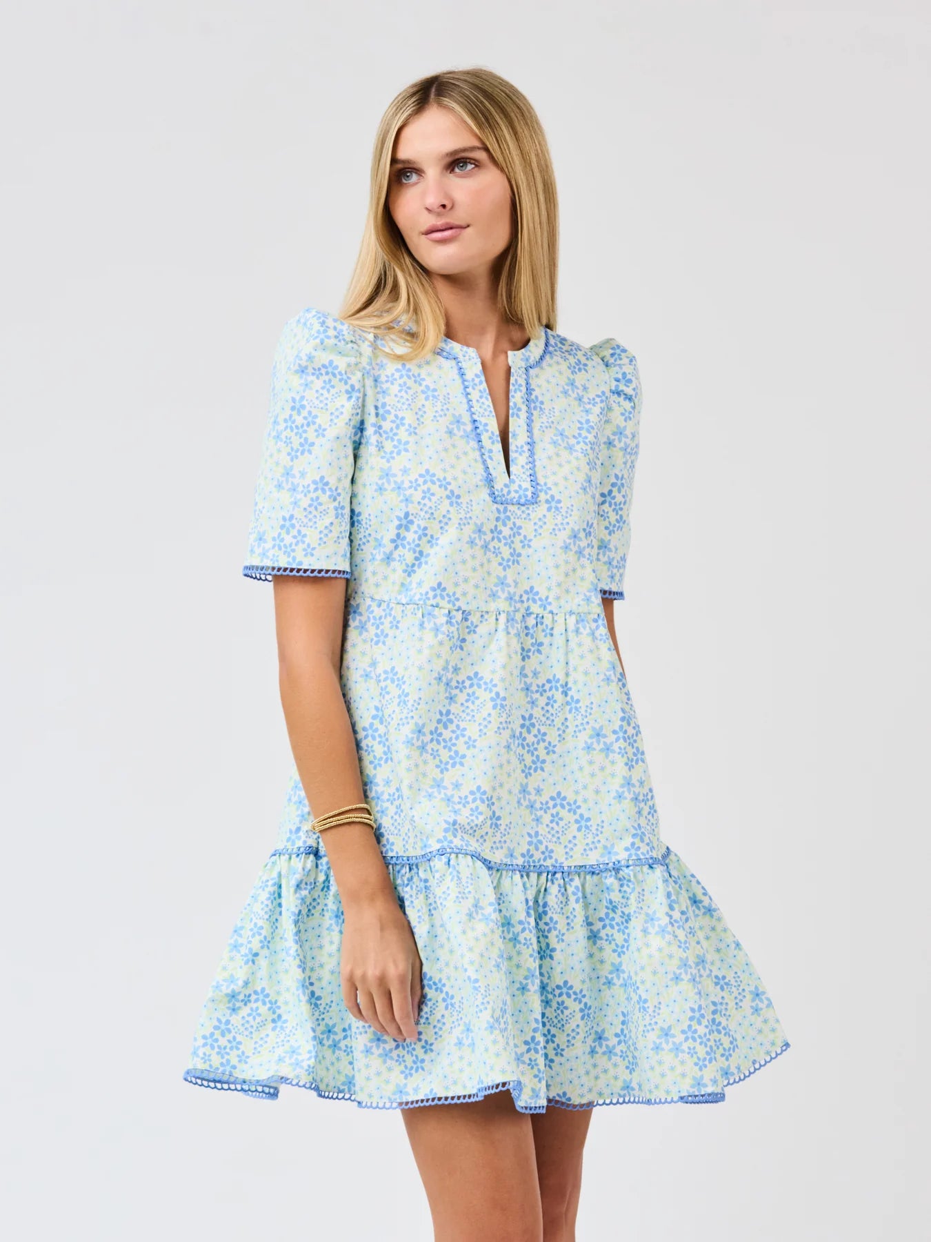 Woman wearing a blue floral dress on a white background