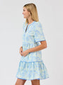 Woman wearing a blue floral dress on a white background