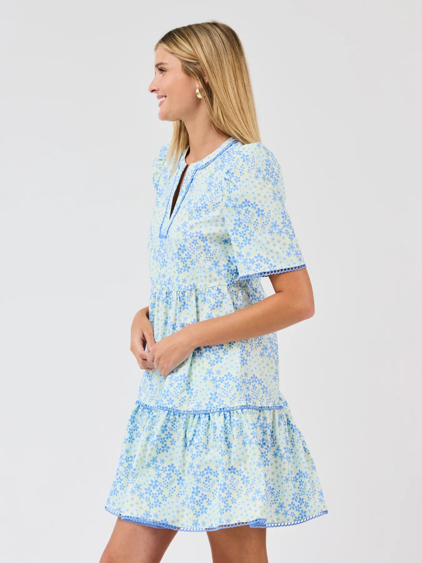 Woman wearing a blue floral dress on a white background