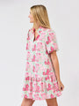 Woman wearing a floral dress on a plain background