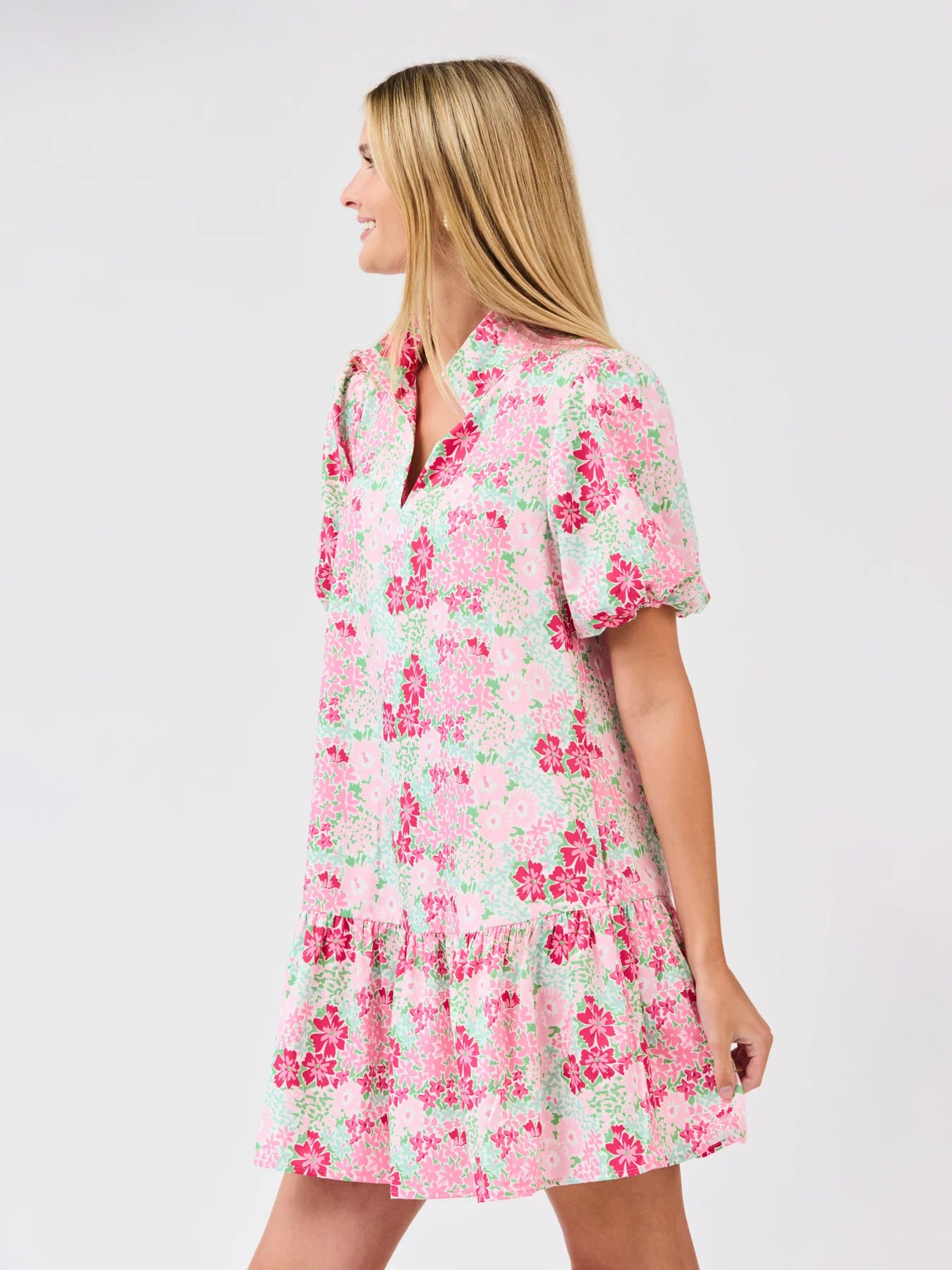 Woman wearing a floral dress on a plain background