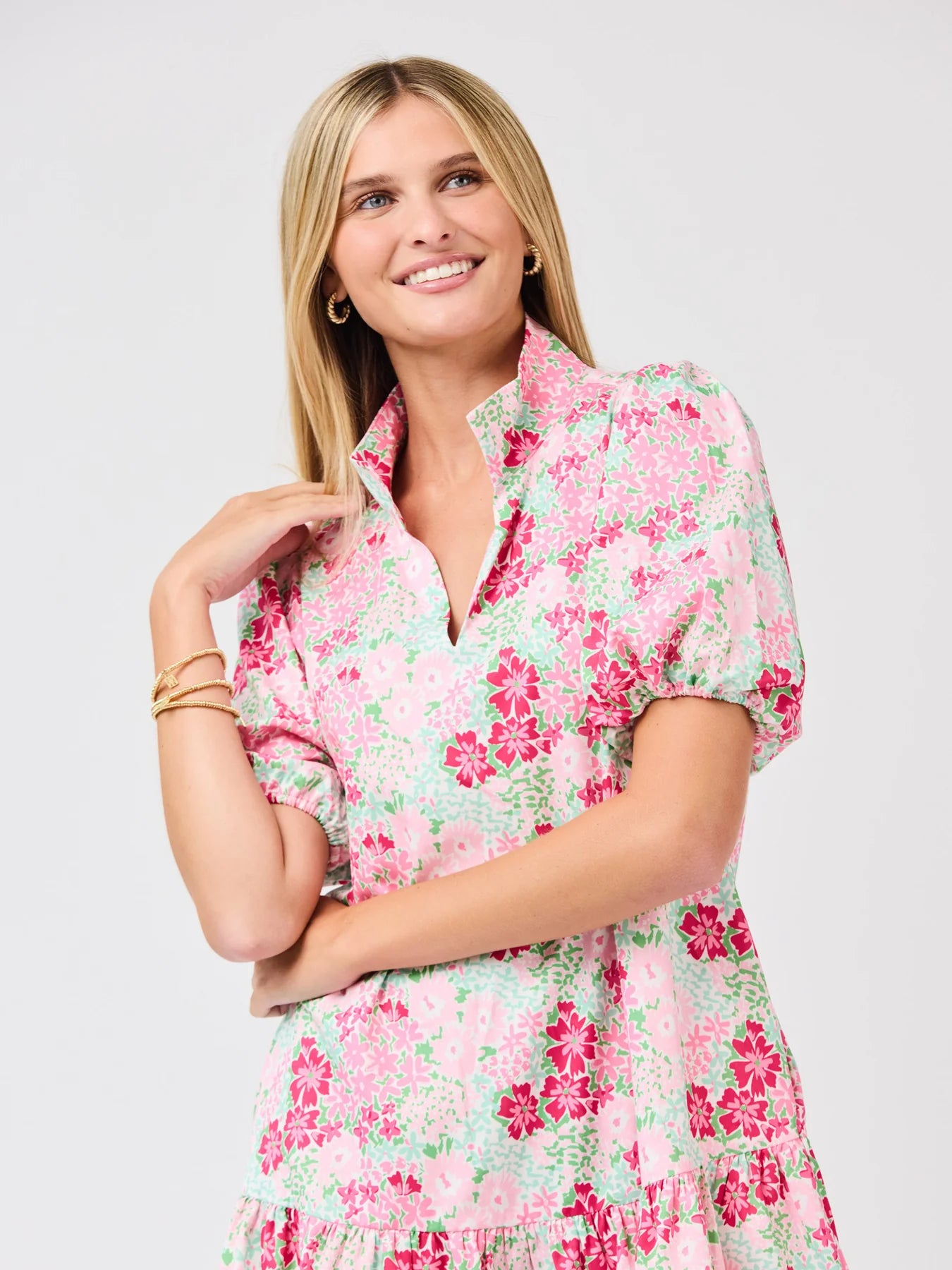 Woman wearing a floral dress on a plain background