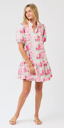Woman wearing a pink floral dress on a white background
