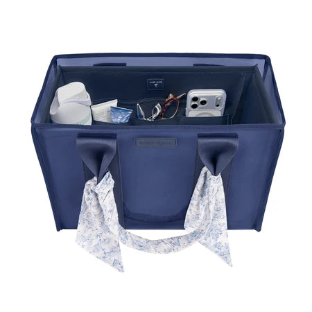 A navy blue fabric organizer bag with two handles, shown open to reveal storage compartments filled with travel accessories. The bag has a small 'LIVING LIFE' brand label on the front and a matching patterned scarf hanging from one of the handles against a plain white background.