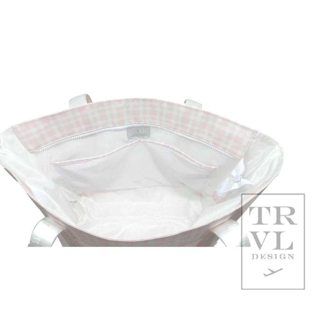 Opening of a white tote bag with visible stitching on a white background, featuring the TRVL Design logo.