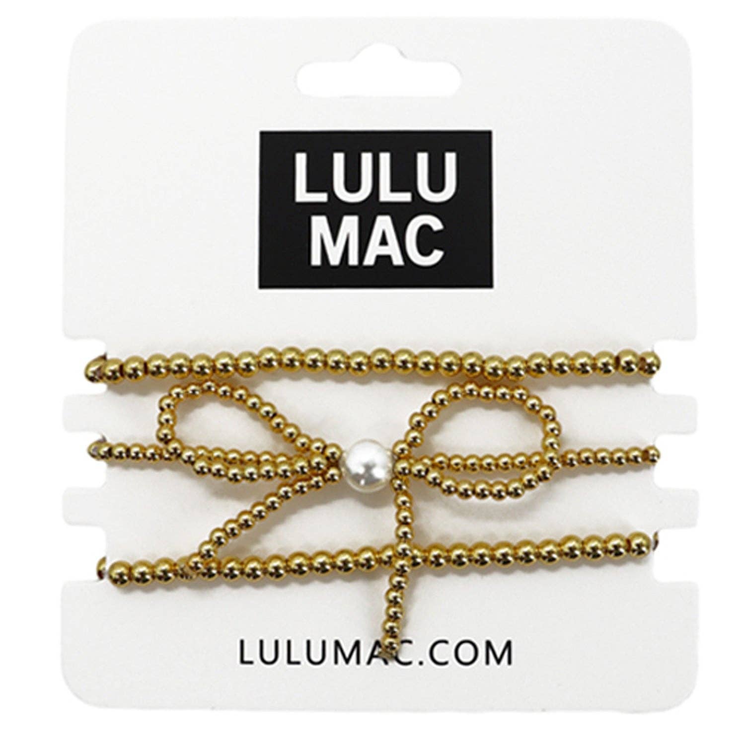 Gold hair bow with pearl center on Lulu Mac packaging