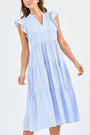 Woman wearing a light blue striped dress on a white background