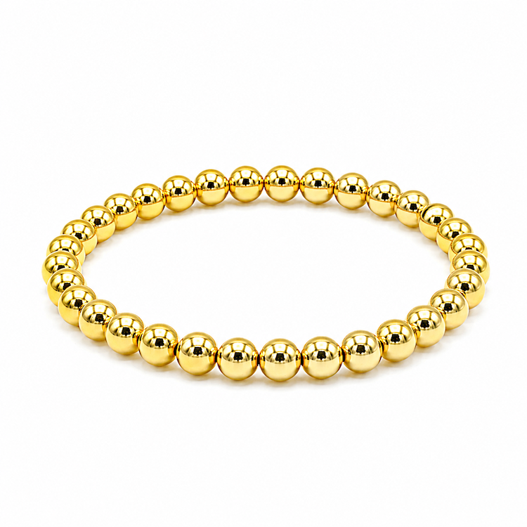 A gold beaded stretch bracelet made of polished, reflective metallic beads, shown on a plain white background.