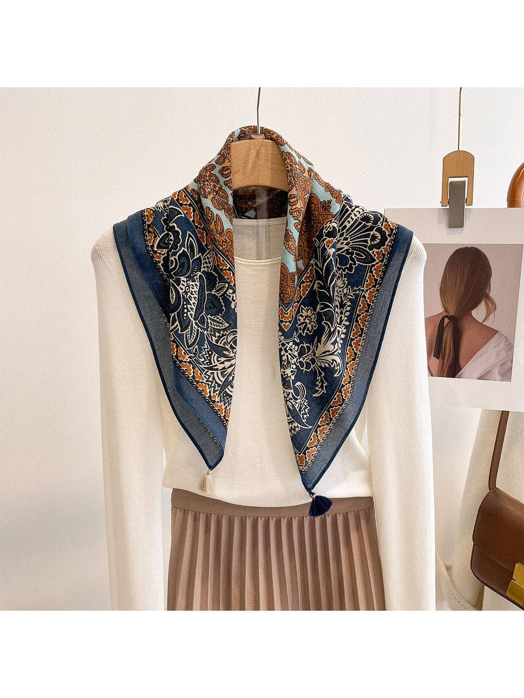 Navy retro floral square scarf with tassels and decorative border, draped on display