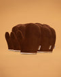 Set of brown self tanning mitts on a beige background