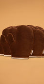 Set of brown self tanning mitts on a beige background
