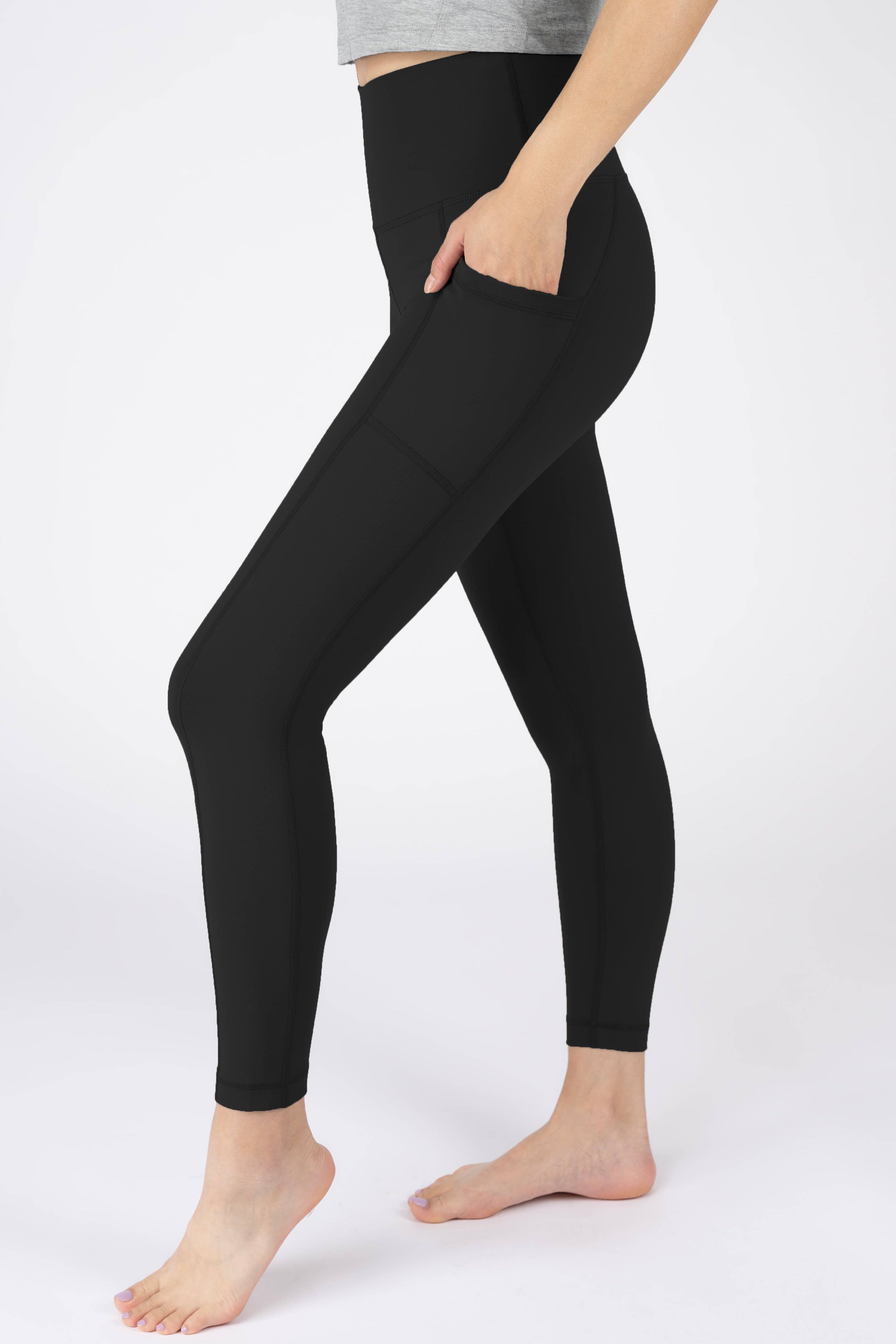 Person wearing black leggings on a white background