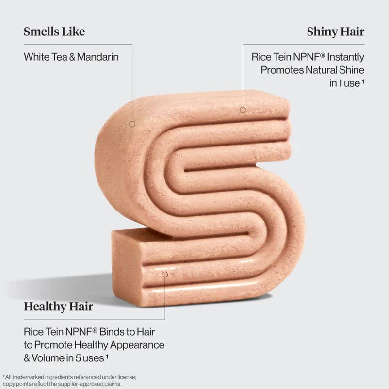 Product with text describing its benefits for hair health and appearance on a light gray background