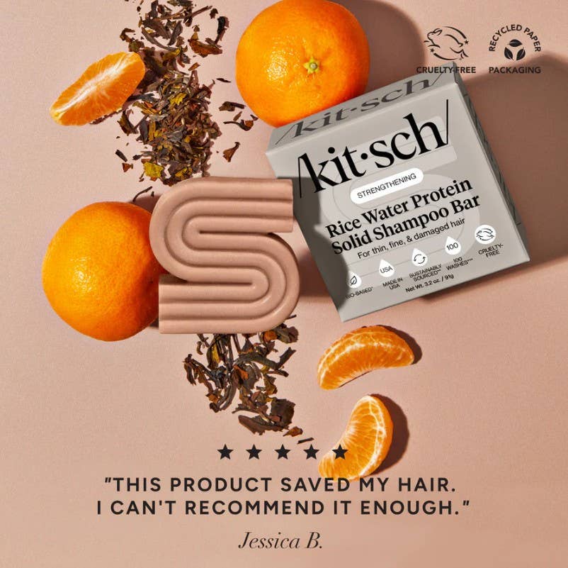 Kitsch rice water protein solid shampoo bar with oranges and tea leaves on a beige background
