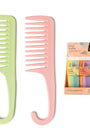 Two combs, one green and one pink, with a box of hair products in the background on a white background.