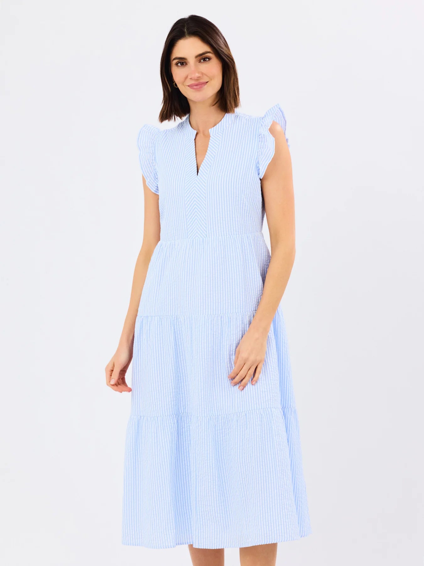 Woman wearing a light blue dress with a white background