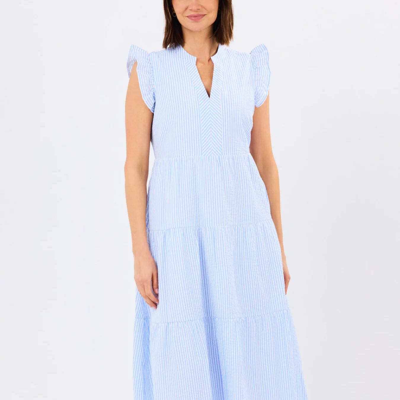 Woman wearing a light blue dress on a white background