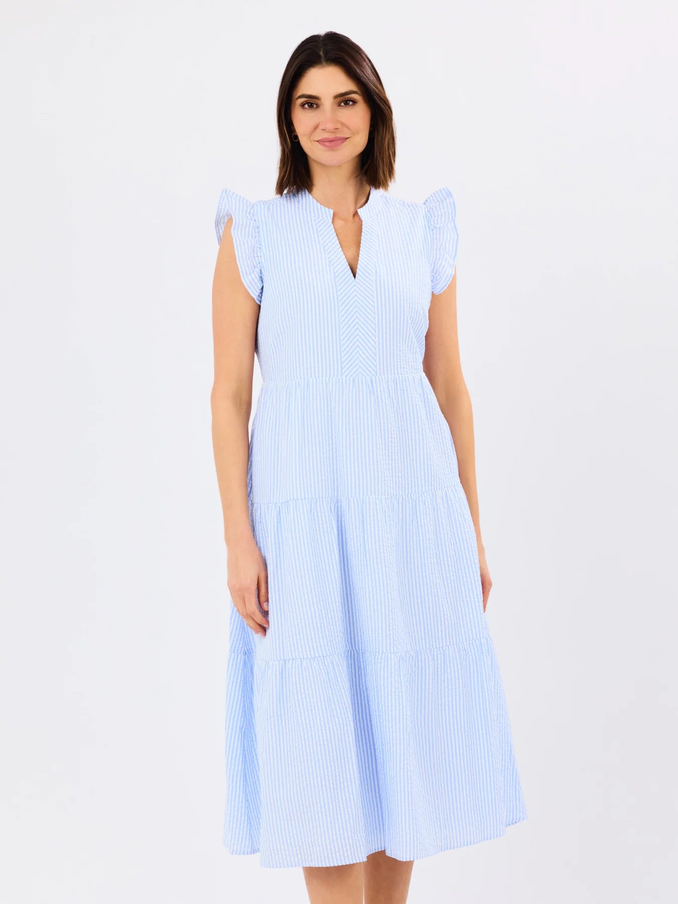 Woman wearing a light blue dress on a white background