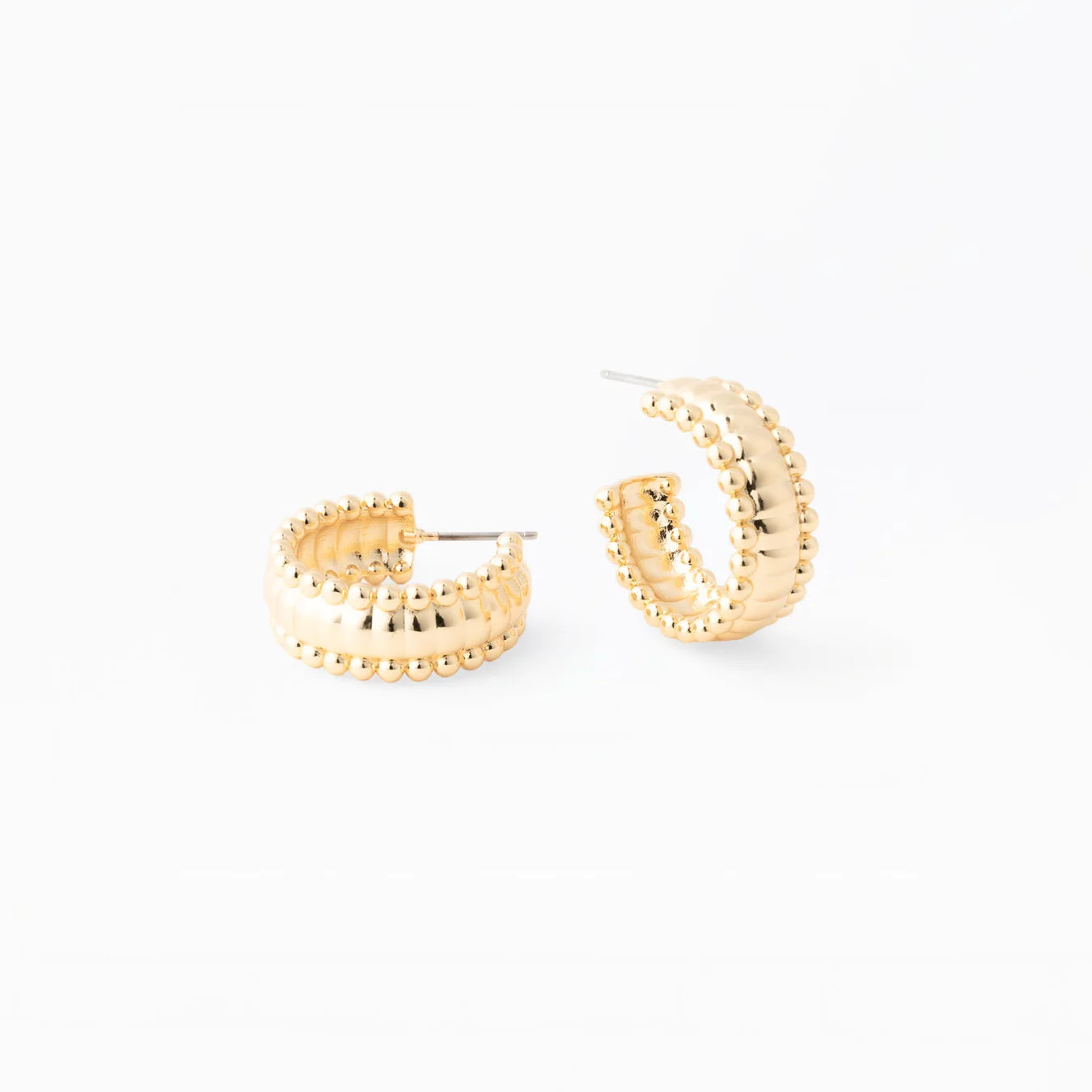 Gold hoop earrings on a white background