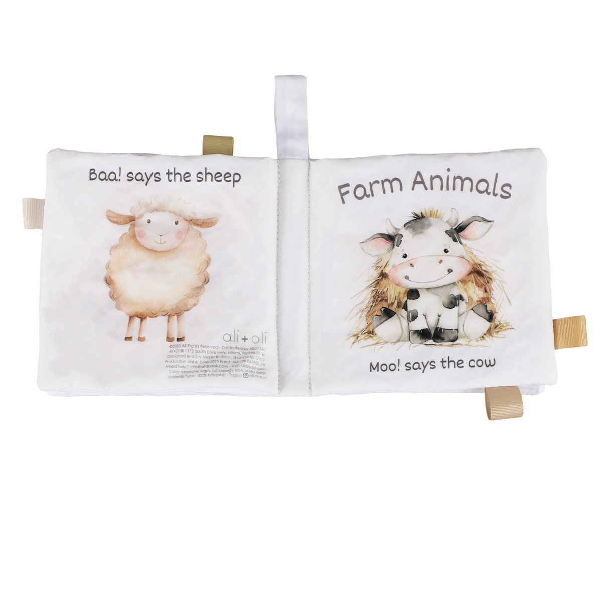 Open soft farm animals cloth crinkle book showing sheep and cow pages with tags