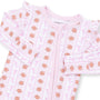 A baby long-sleeve footless pajama top in light pink, featuring an all-over print of brown footballs and pink bows, with a front zipper and ruffled cuffs.
