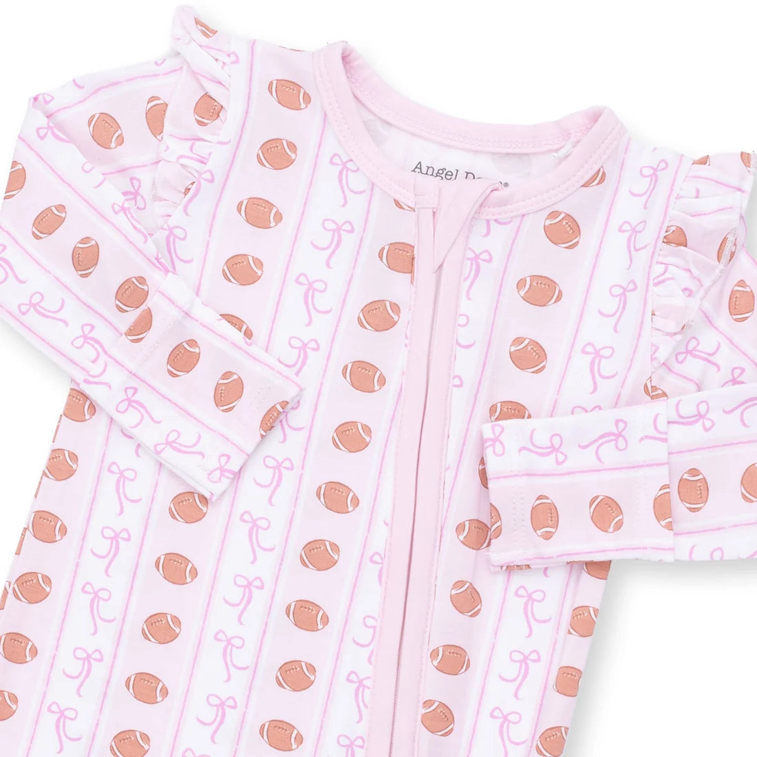 A baby long-sleeve footless pajama top in light pink, featuring an all-over print of brown footballs and pink bows, with a front zipper and ruffled cuffs.