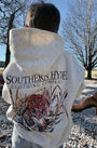 Person wearing a hoodie with 'Southern Hyde Clothing Company' logo outdoors.