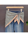 Leopard print triangle bandana with cream and peachy-pink contrast border, knotted center