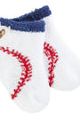 Pair of white socks with red stitching and blue fuzzy top on a white background