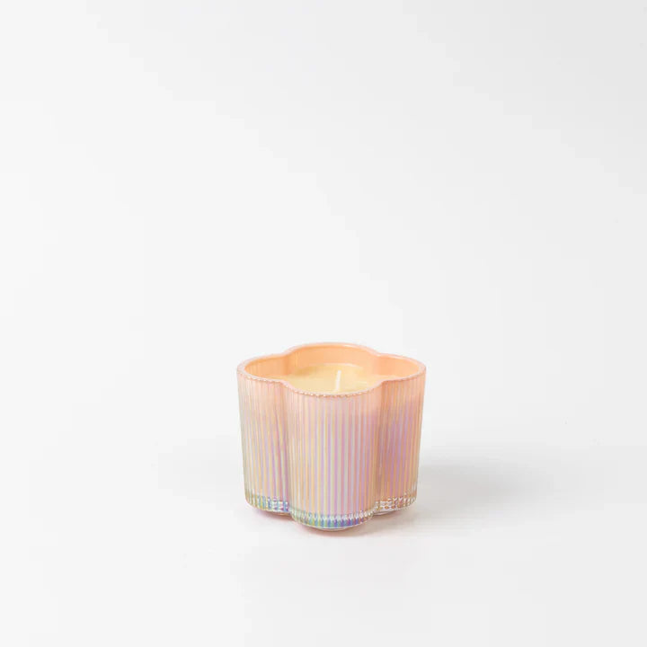 Iridescent candle holder with a candle inside on a white background