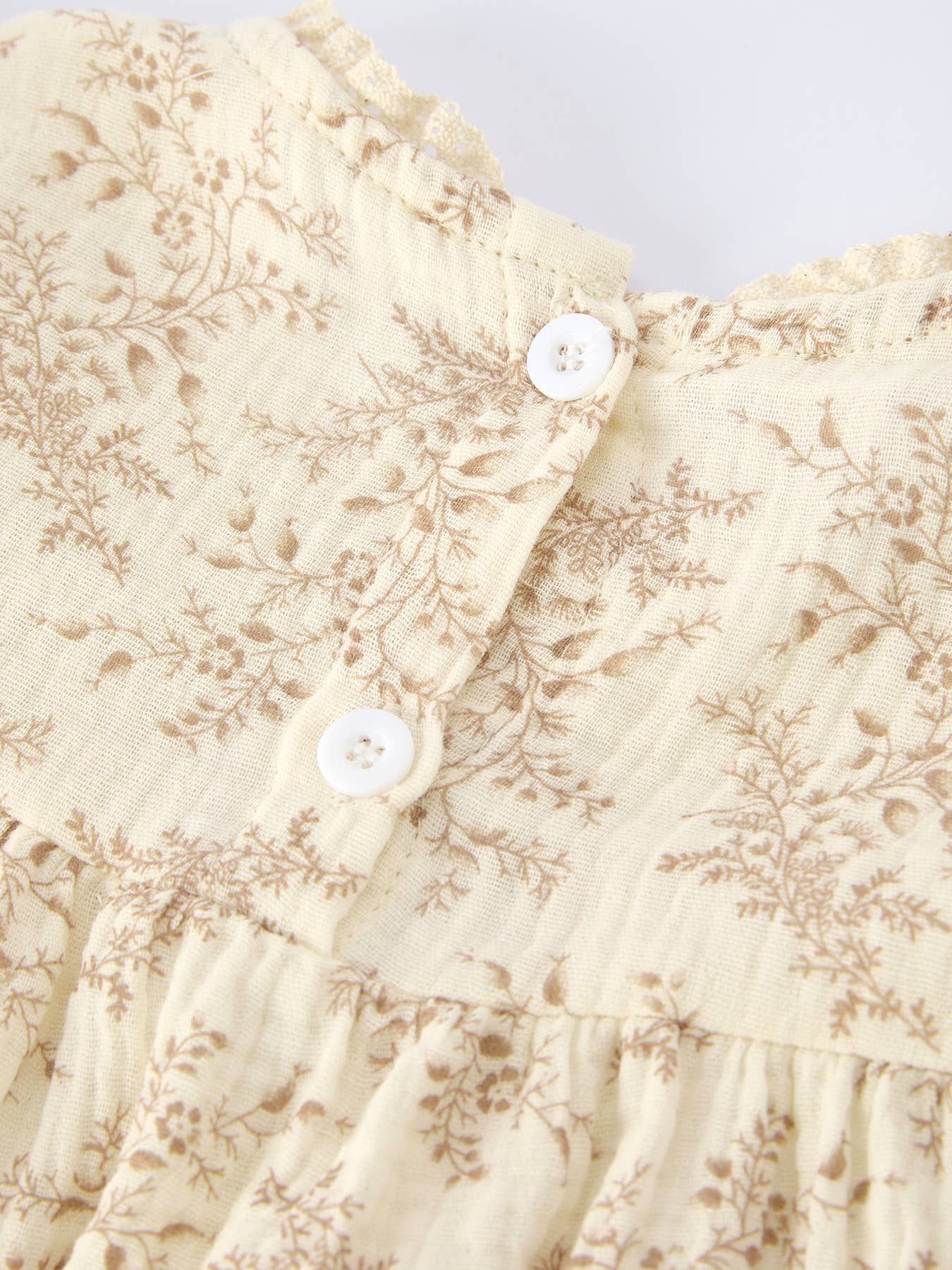 Floral patterned fabric with white buttons on a light background