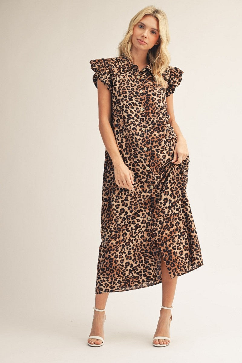 Woman wearing a leopard print dress on a plain background