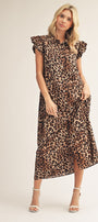 Woman wearing a leopard print dress on a plain background