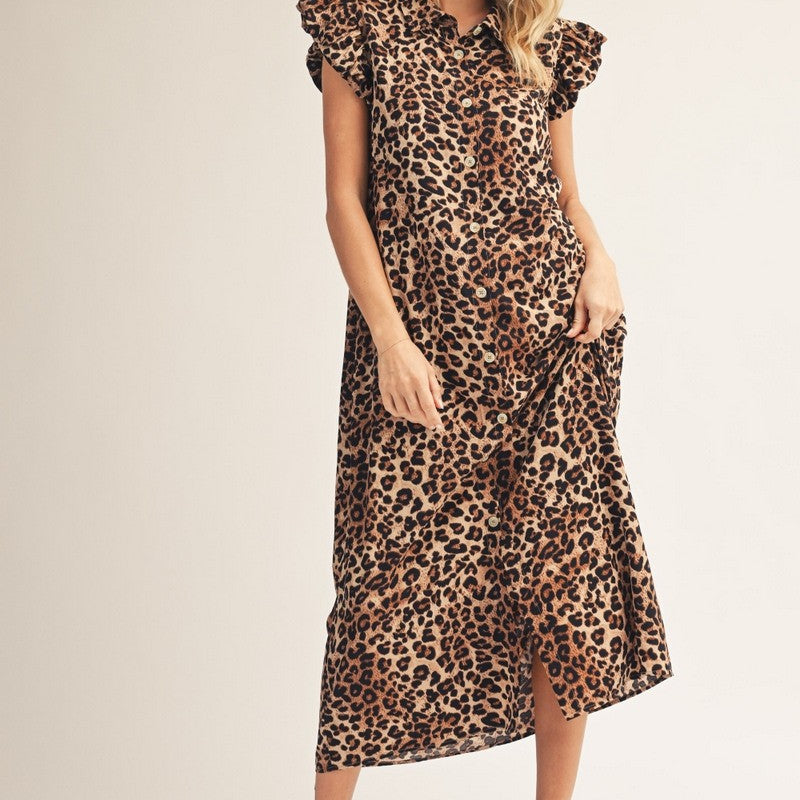 Woman wearing a leopard print dress on a plain background