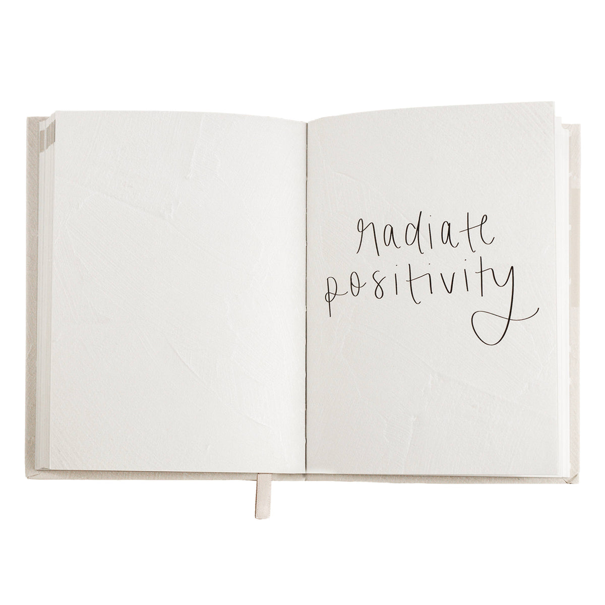 Open devotional book with handwritten-style words 'gratitude' and 'positive' on pages