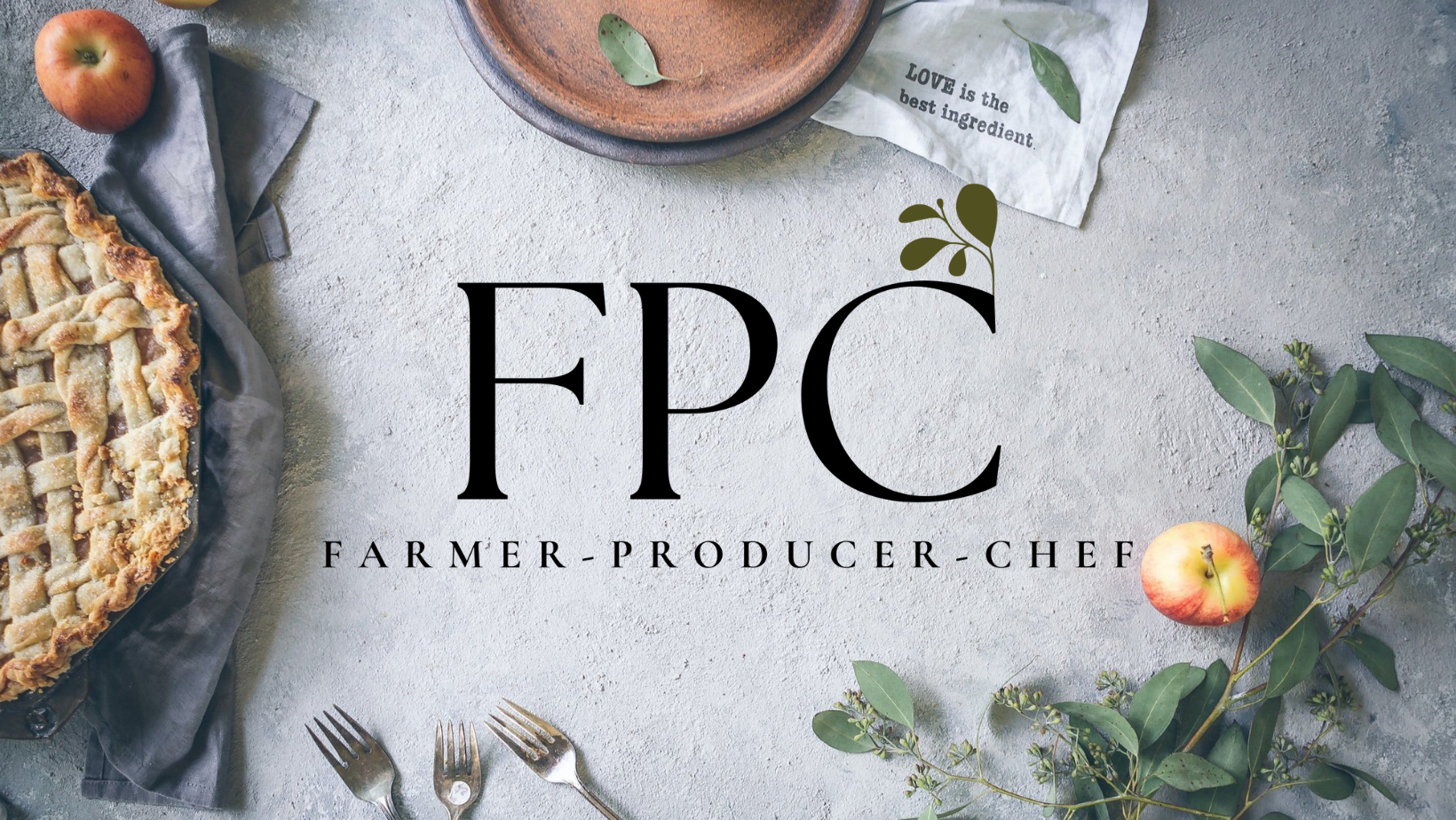 Apple pie, apples, and greenery on a table with 'FPC' branding.