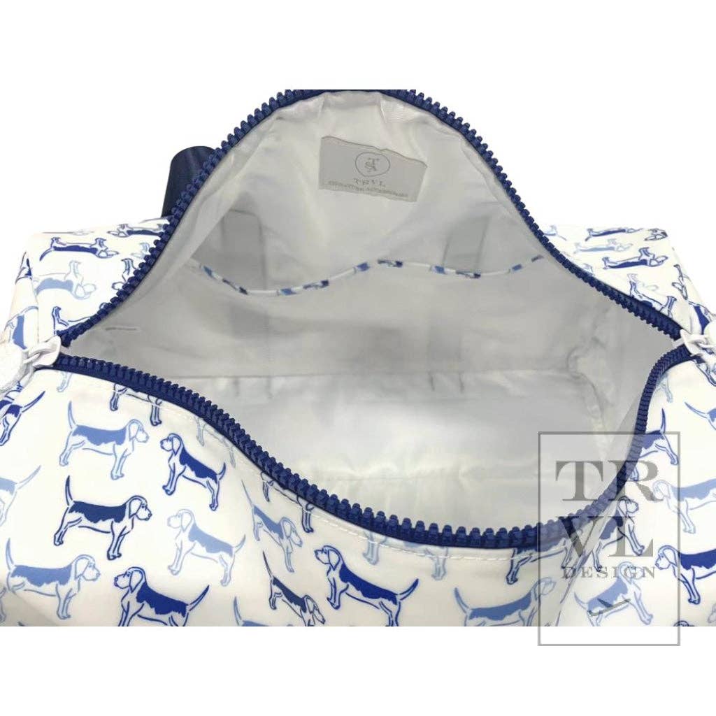 Opening of a patterned duffle bag with blue dog illustrations on a white background