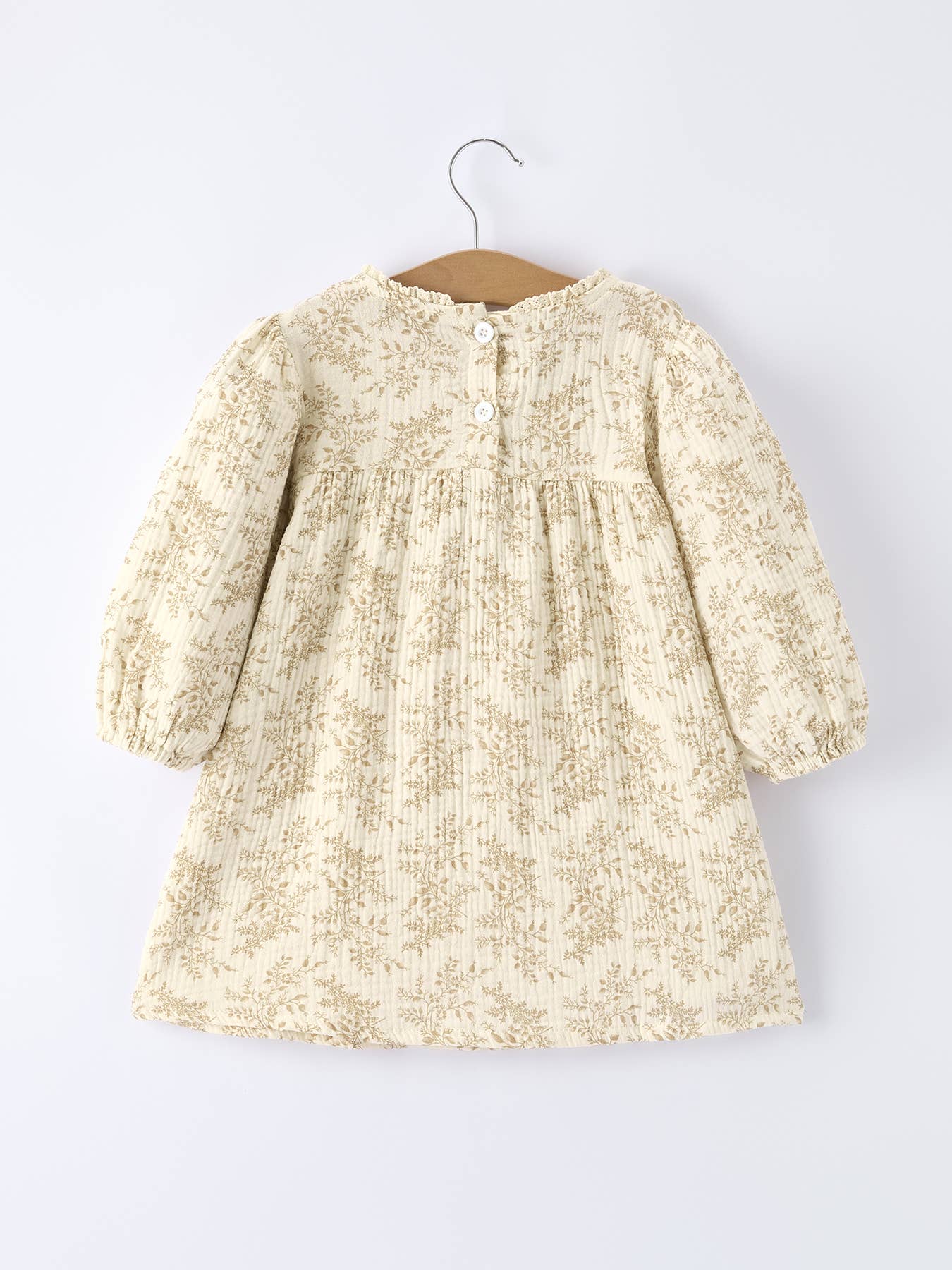 Floral dress on a hanger against a white background