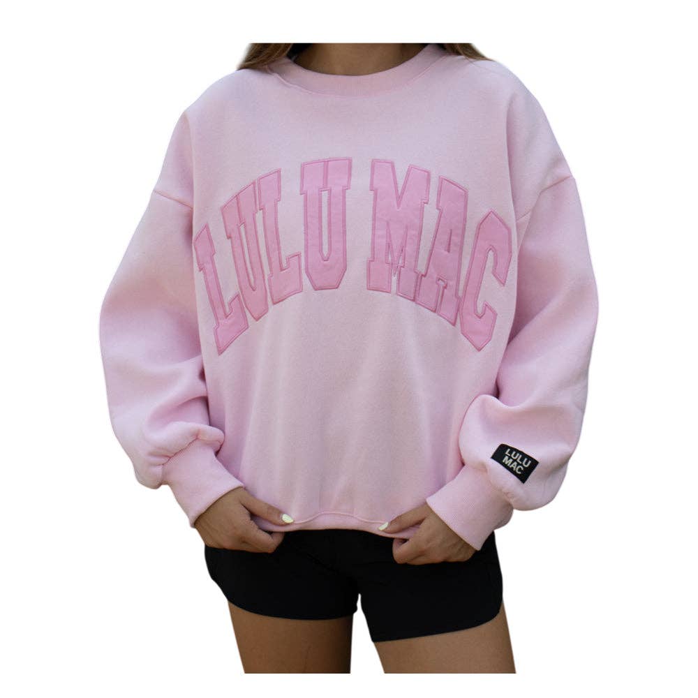 Pink sweatshirt with 'LULU MAC' text on a white background