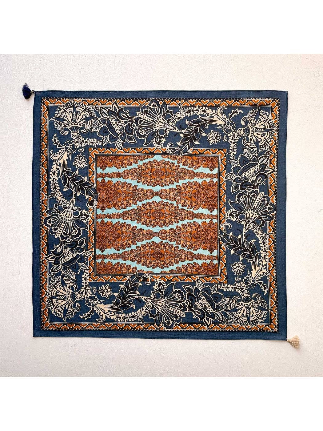Navy retro floral square scarf, flat lay with ornate border and small tassel ends