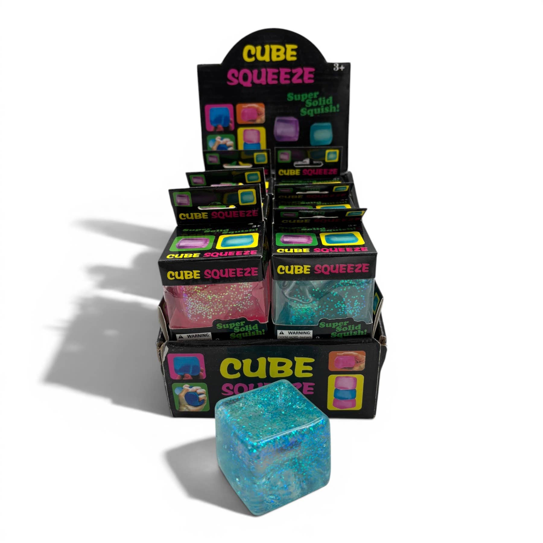 Display of Cube Squeeze toys with a blue glittery cube in front.