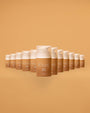 Row of Peta Jane sunless tanning products on a matching brown background
