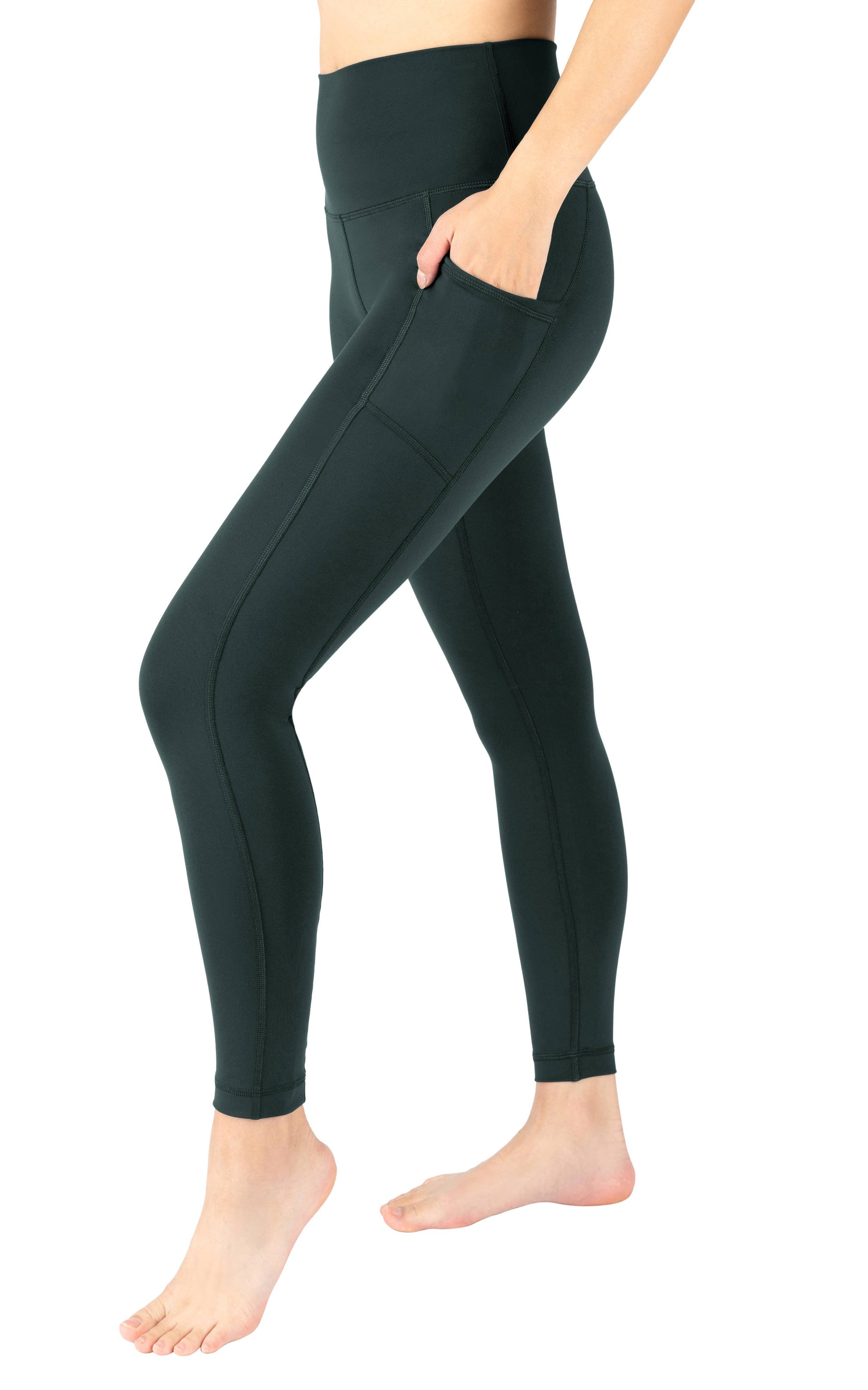 Person wearing dark green leggings on a white background