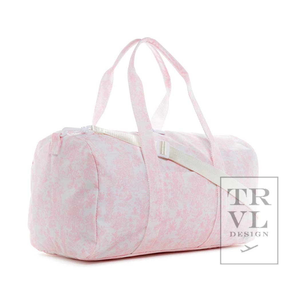 Pink duffel bag with white accents on a white background, featuring the TRVL Design logo.