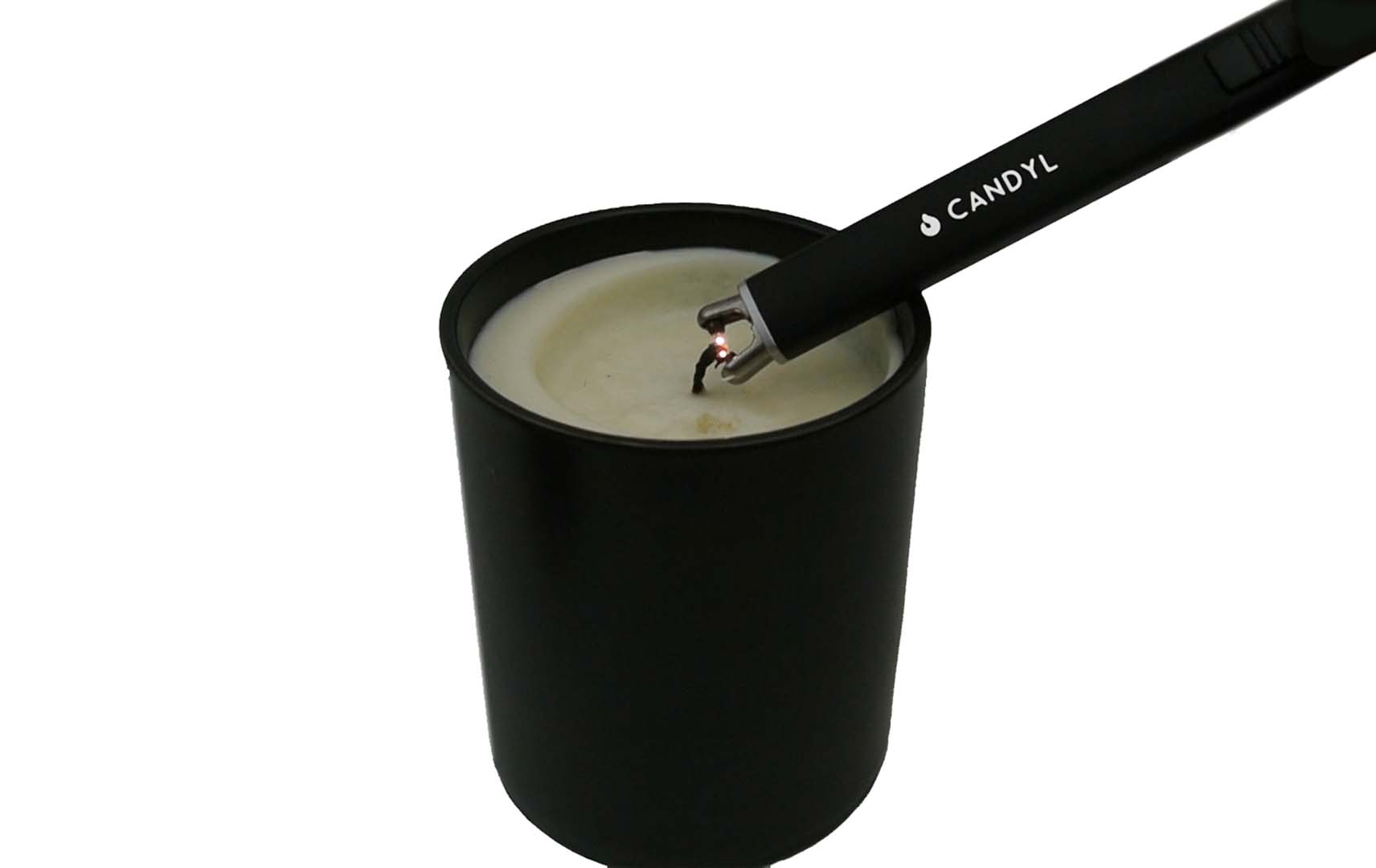 Black candle lighter with a lit candle inside a black container on a white background