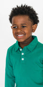Child wearing a green long-sleeve shirt on a white background