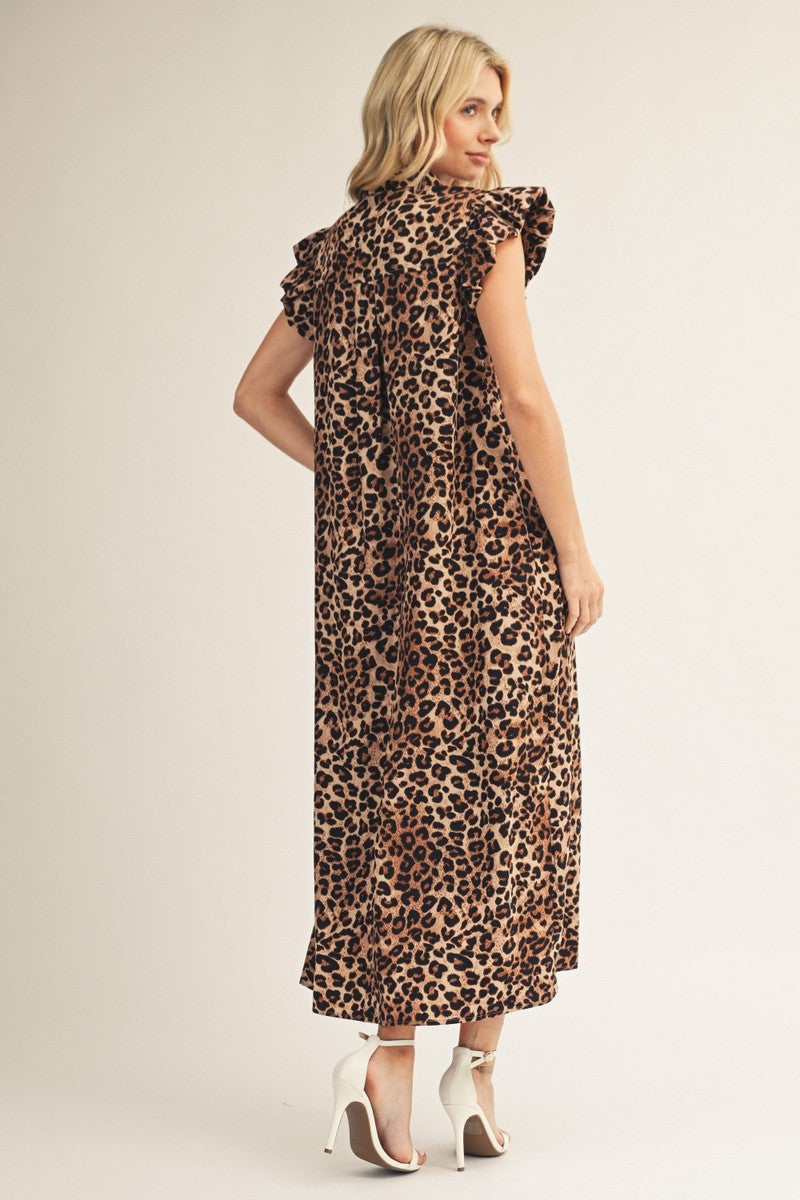 Woman wearing a leopard print dress on a plain background