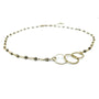 Gold necklace with interlocking rings on a white background